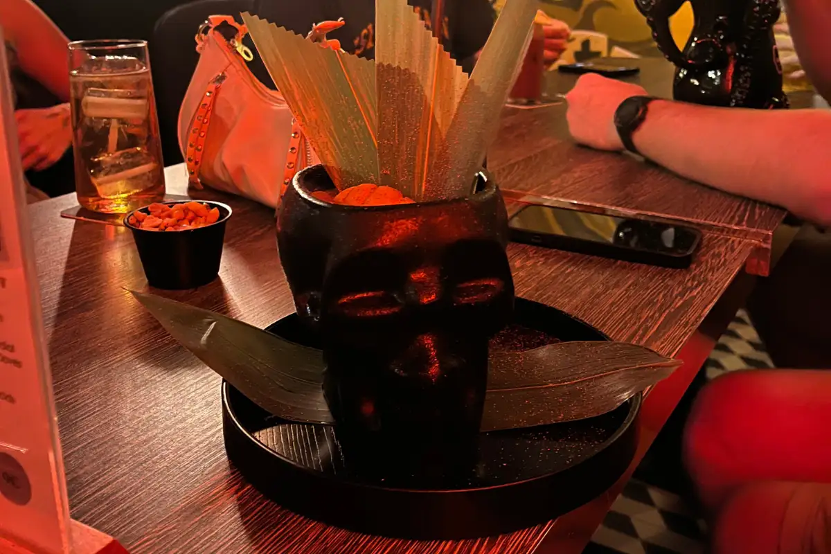 Skull-shaped cocktail garnished with palm fronds served at Chester and Punk bar, Málaga