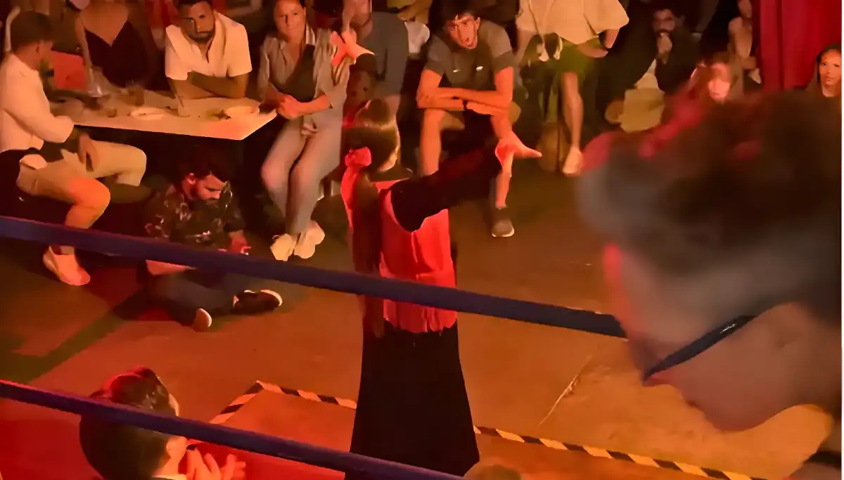 Flamenco dancer in a red dress performing at close range in a Seville tablao