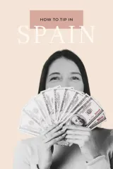 Woman holding a fan of banknotes illustrating tipping customs in Spain