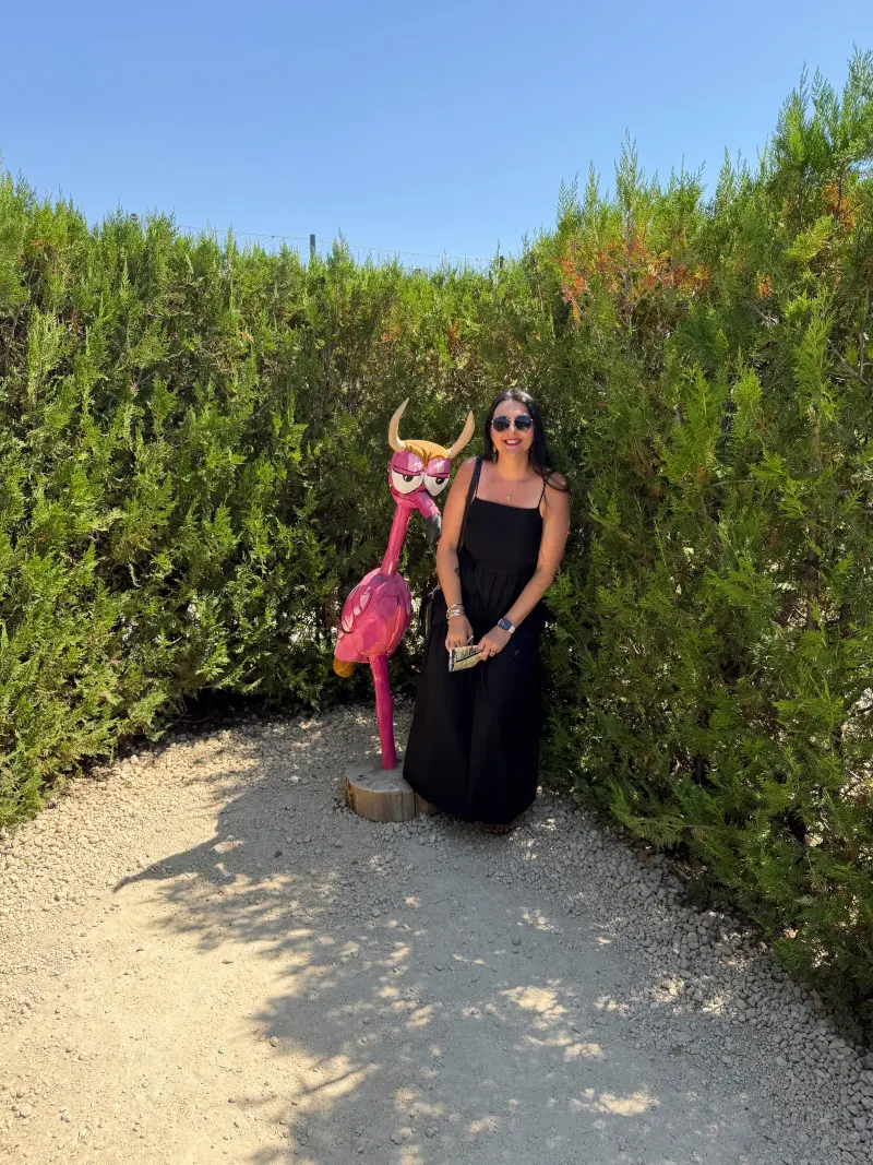 Heidi beside a flamingo and bull sculpture at Laberintus Park near Antequera