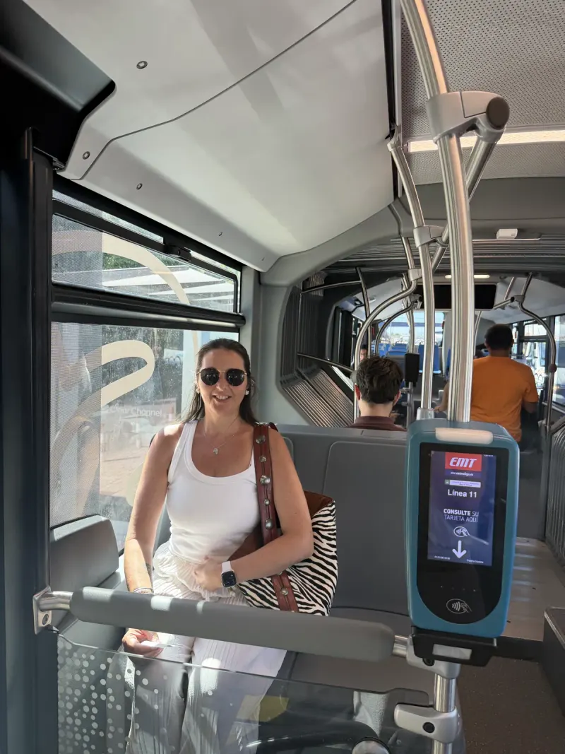 Heidi sitting on an EMT Line 11 bus in Málaga next to the ticket validator