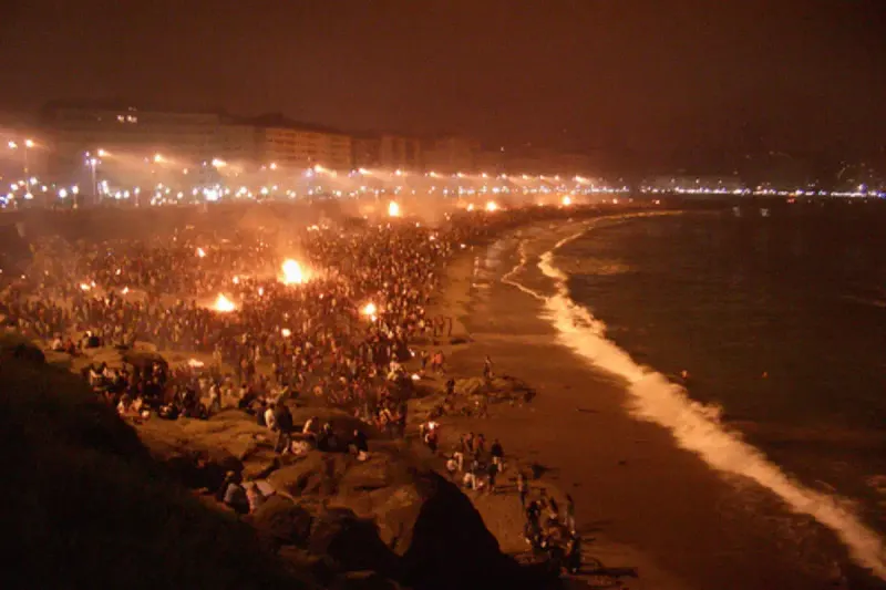 Bonfires burning on a Malaga beach at night during Noche de San Juan