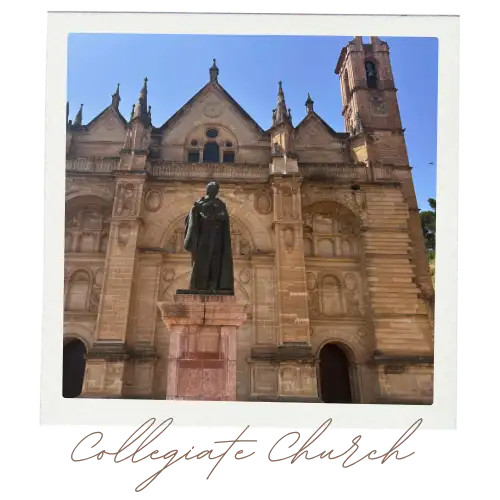 Front view of the  Antequera Cathedral with the statue in front.