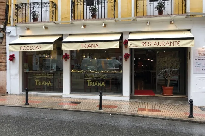 The street facade of Bodegas Triana restaurant in Antequera with its awnings and windows