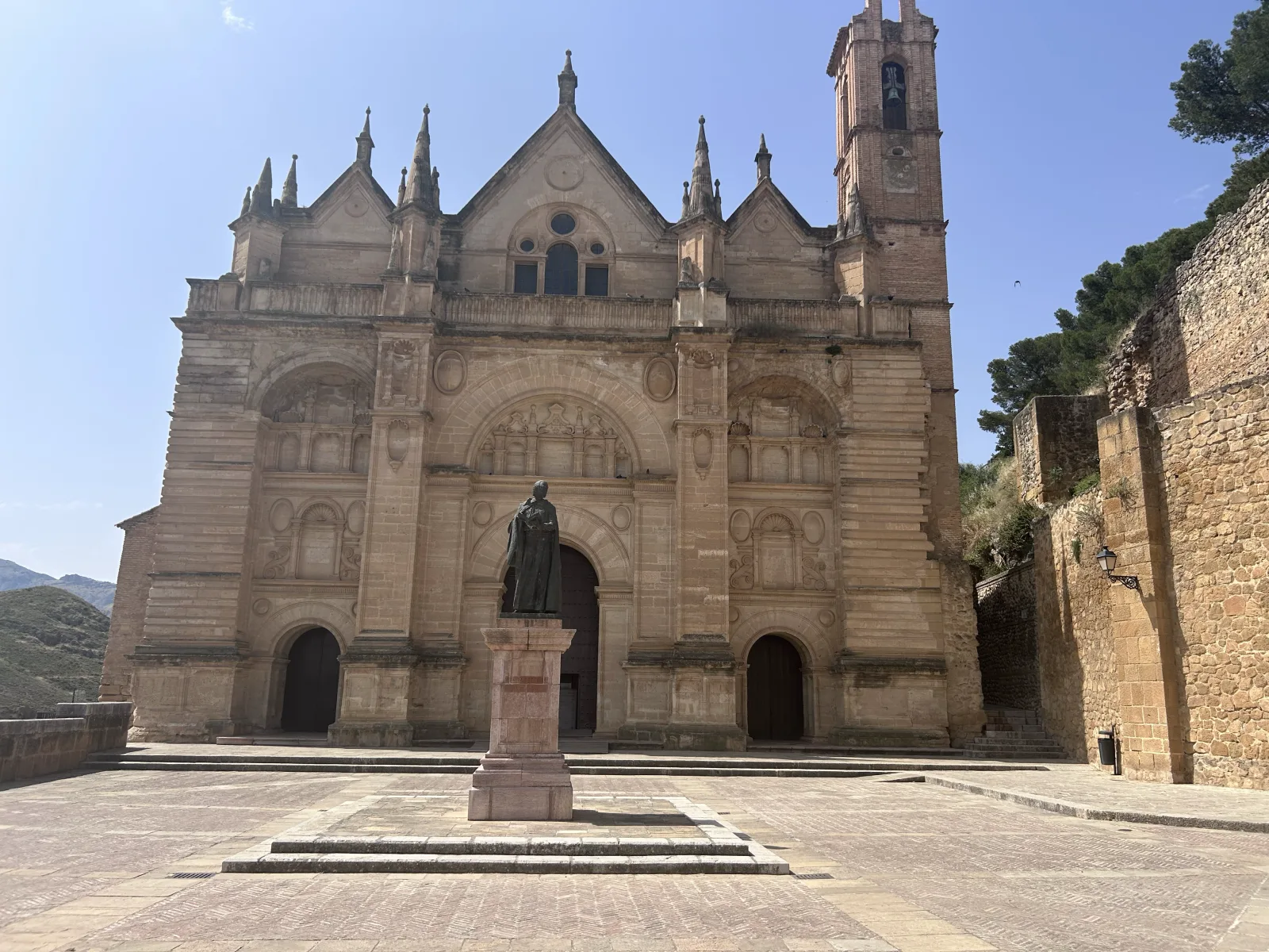The Renaissance facade of the Colegiata de Santa María la Mayor with a statue in the plaza in Antequera