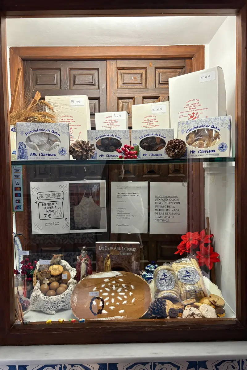Handmade convent sweets displayed in a glass cabinet at an Antequera nunnery