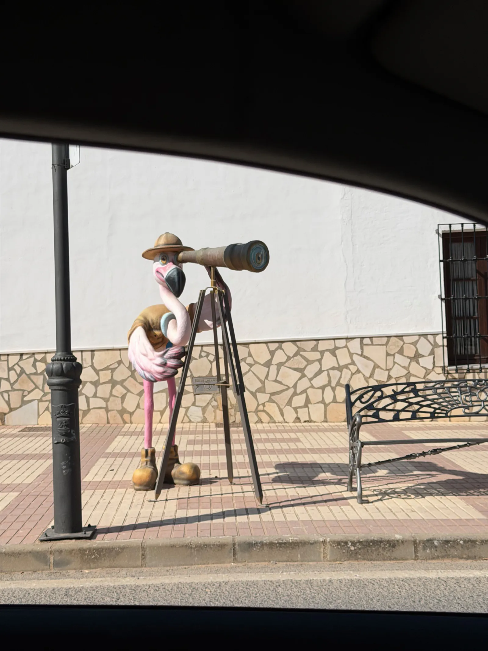 Flamingo sculpture looking through binoculars in Fuente de Piedra