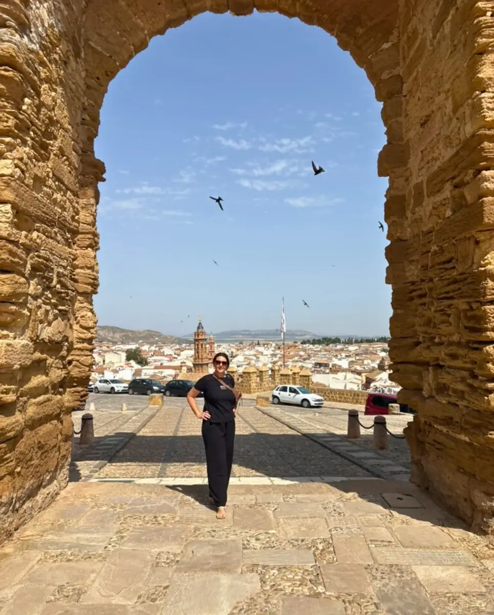 a womn standing on front of the famous archway at Antequera