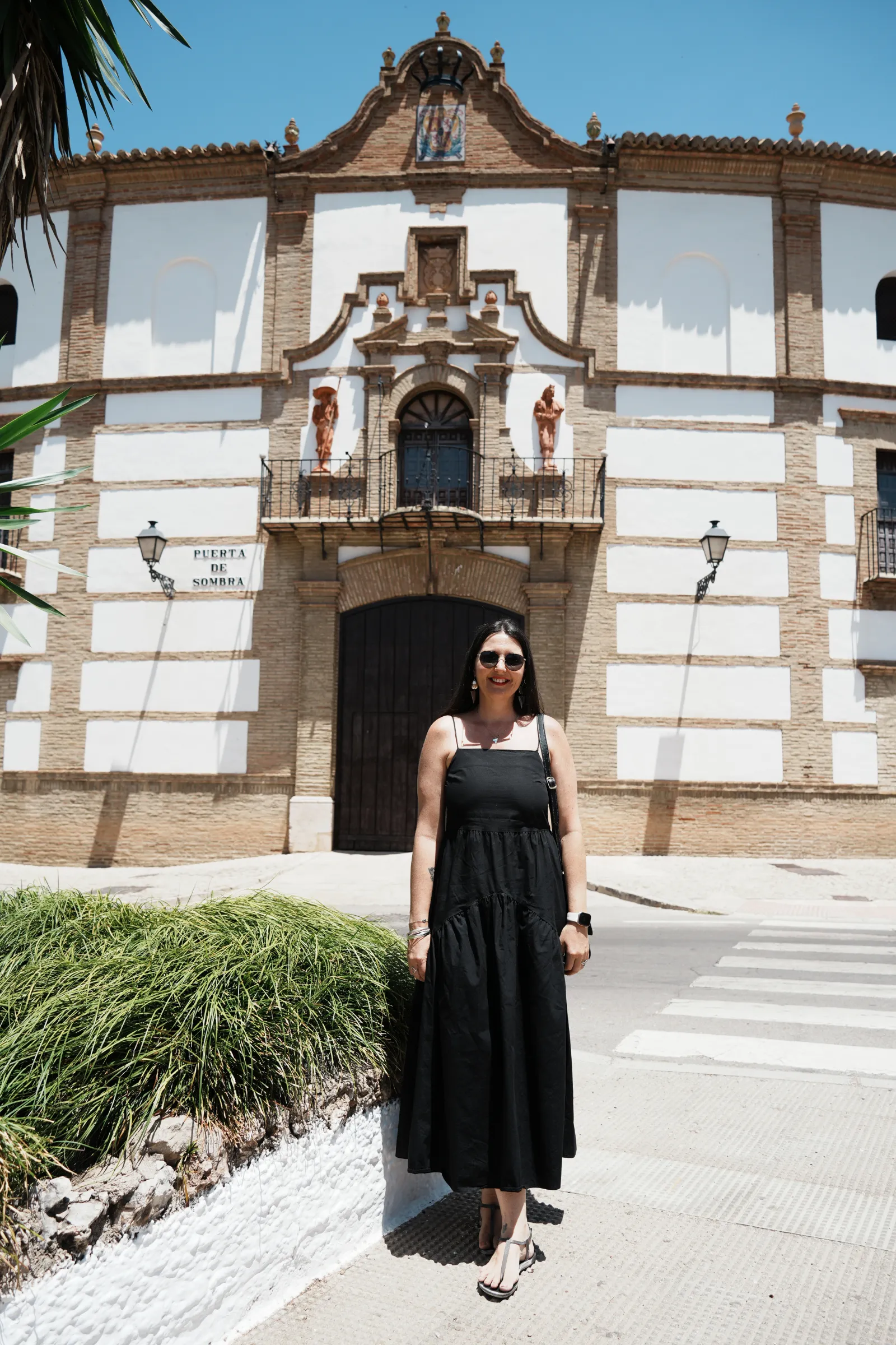 Heidi standing in front of the Puerta de Sombra gate of Antequera's bullring