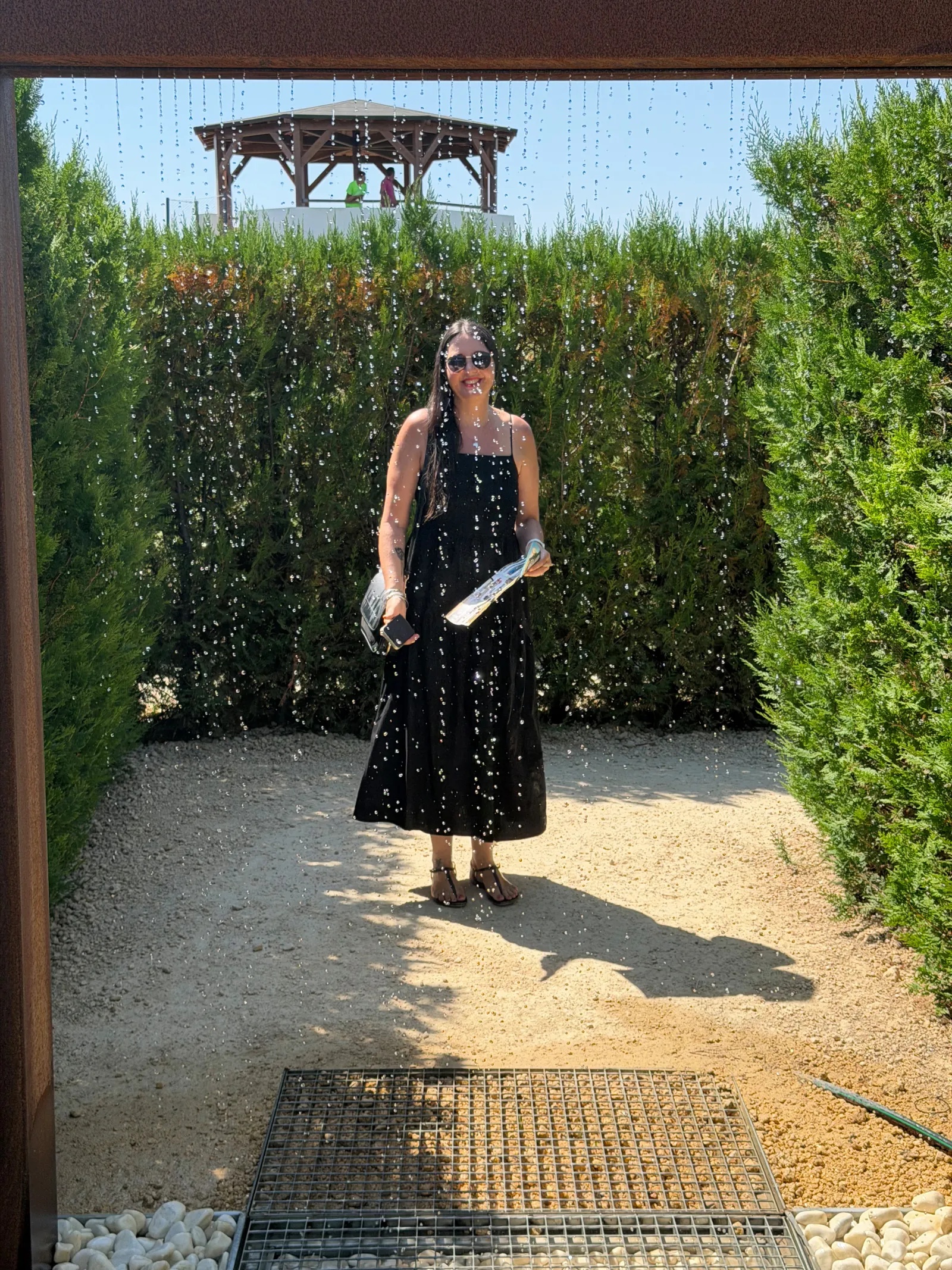 Walking through a water curtain archway at Laberintus Park