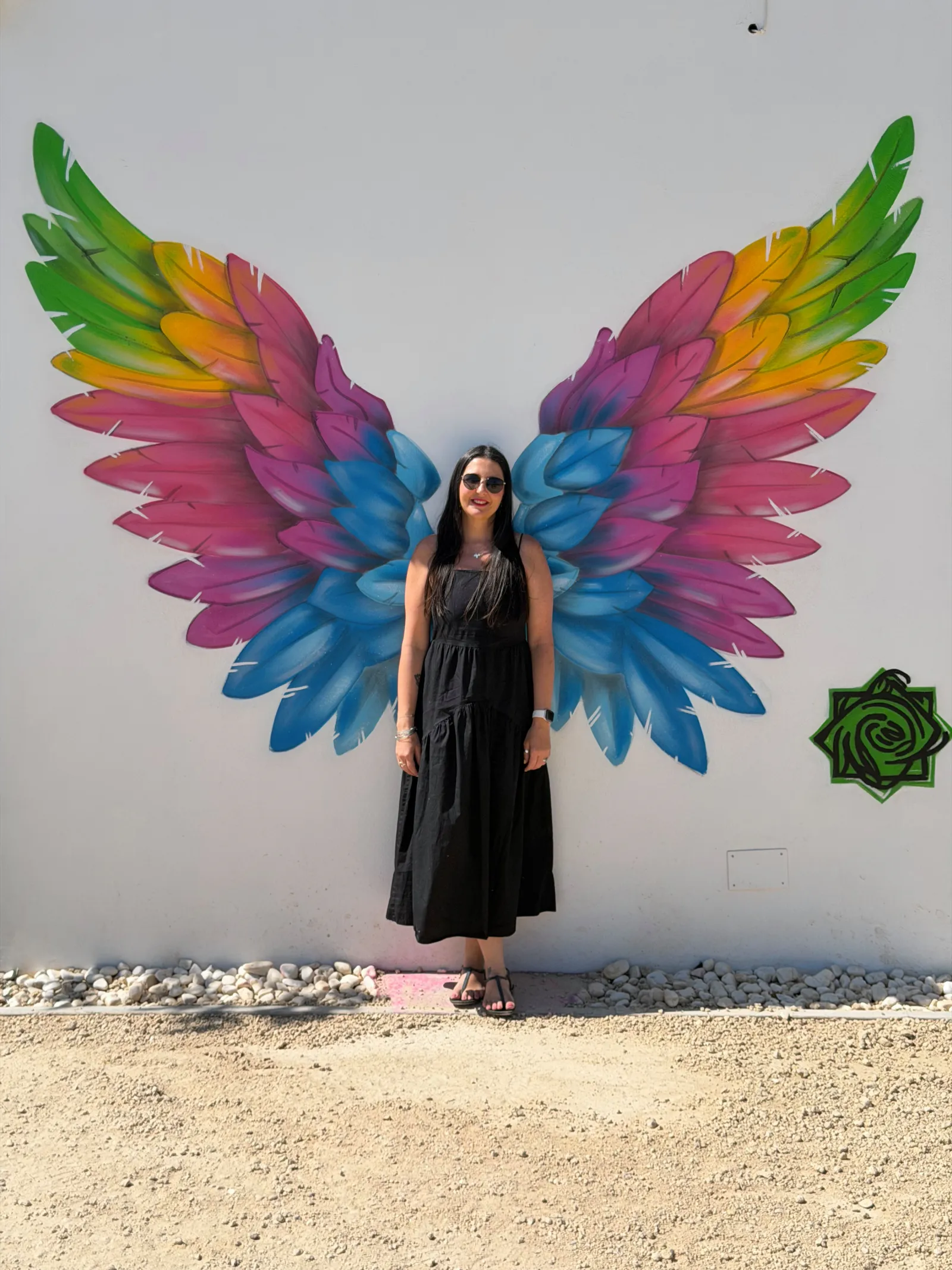 heidi standing in front of colourful wings at the laberintus park in antequera