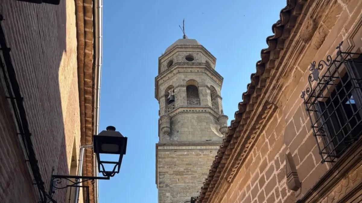 Baeza church bell tower rising between old stone buildings in the historic centre