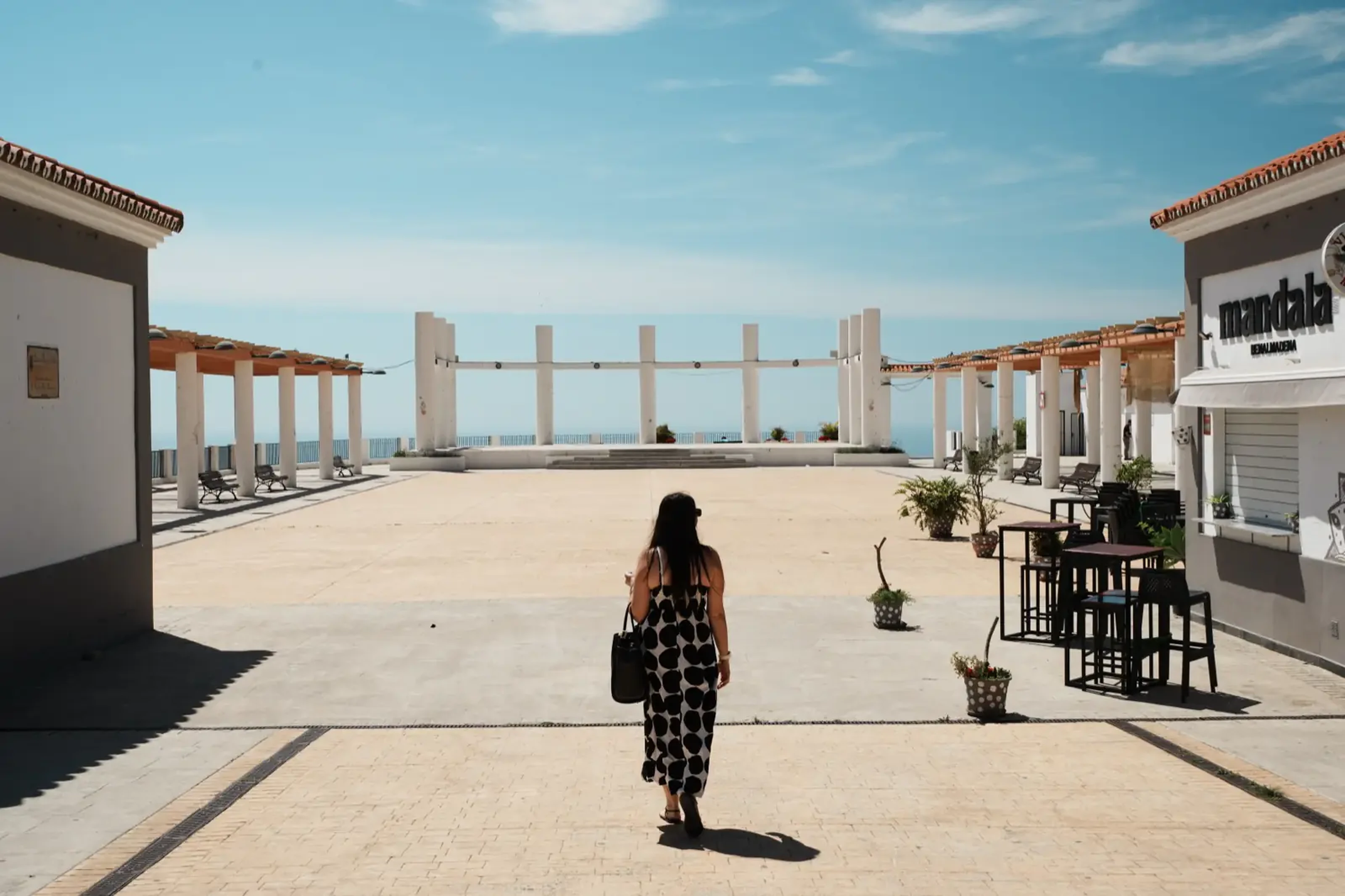 Woman walking through the Recinto Ferial Los Nadales fairground area in Benalmádena