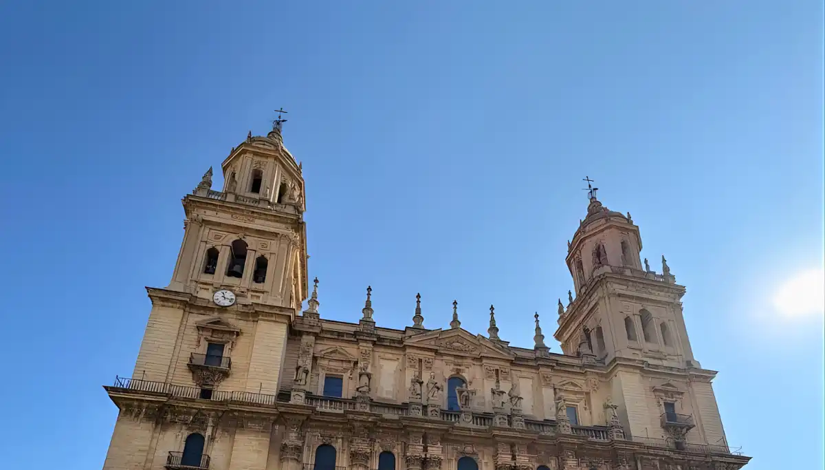 Jaén Cathedral facade with twin towers against a clear blue sky