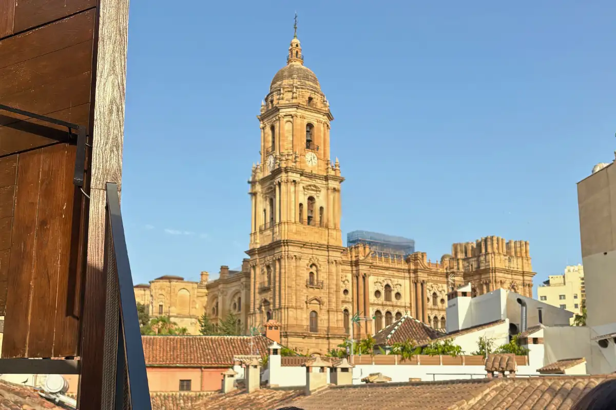 Malaga cathedral with a blue sky background taken from Chinitas Urban Hostel rooftop bar in Malaga Old Town.