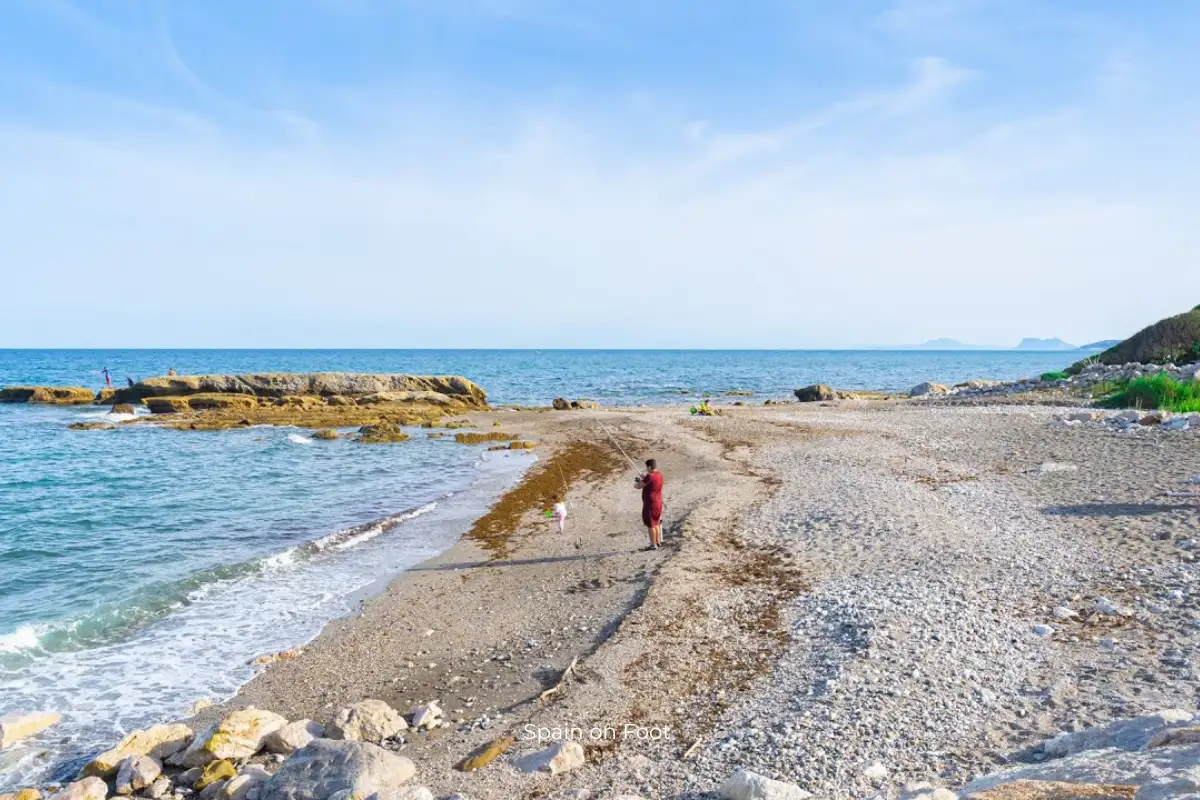 A man and a child are fishing on the beach at Playa Bahia Dorada.