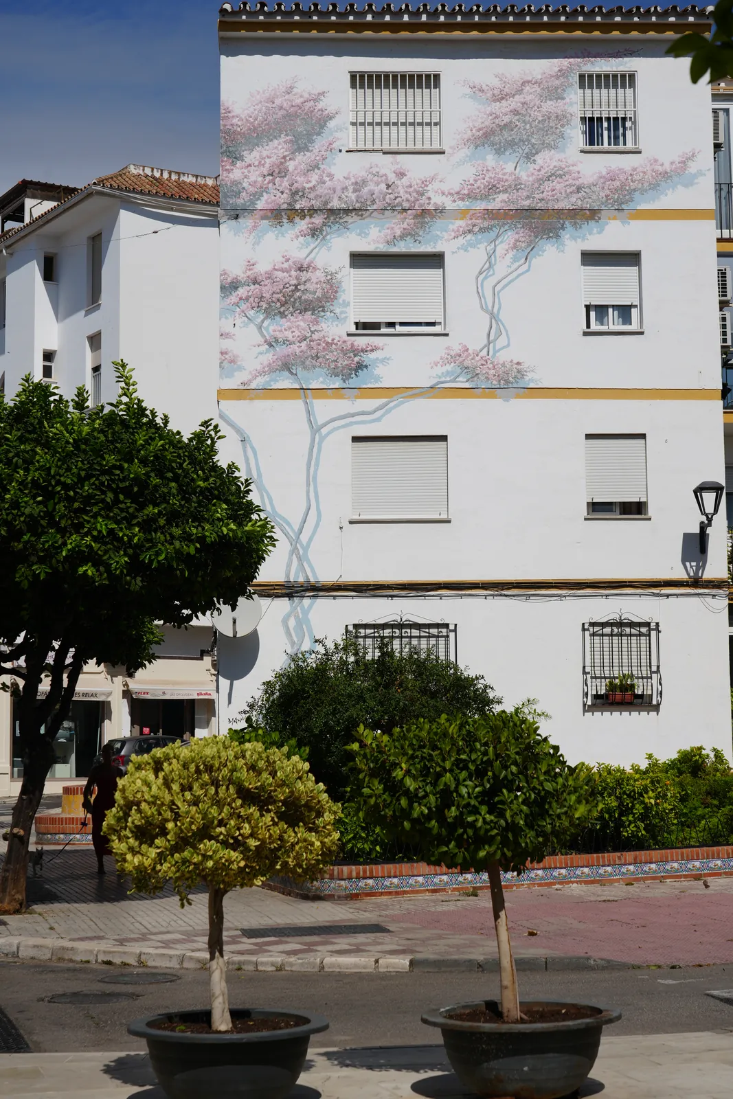 Pale pink blossom tree mural on an apartment building in Estepona