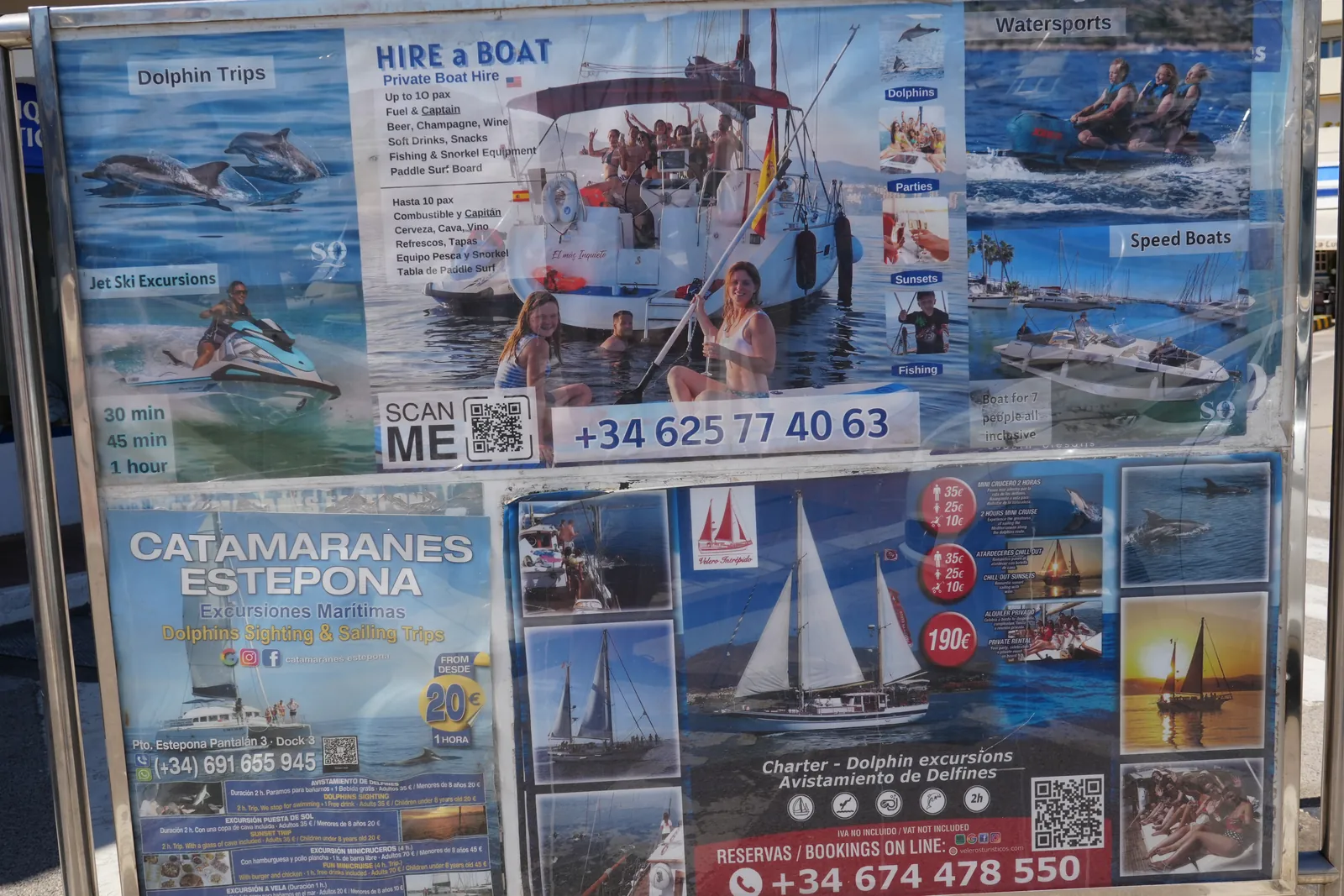 Noticeboard at Estepona port advertising dolphin trips, boat hire, jet ski excursions and sunset sailing