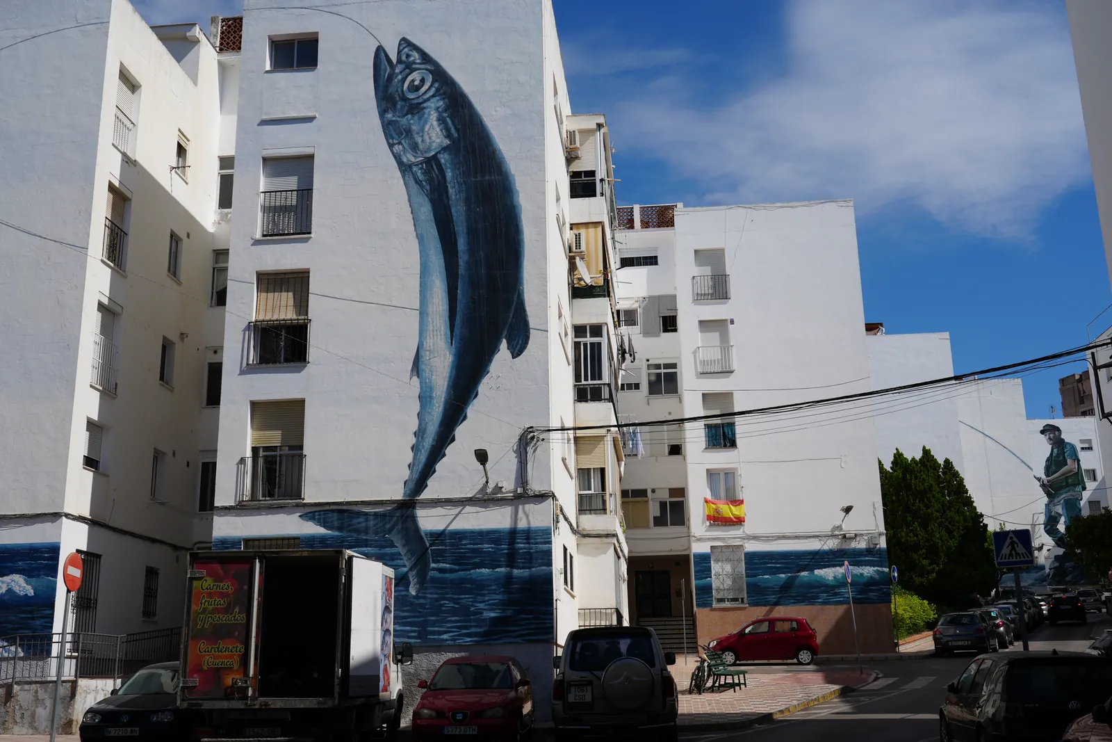 Giant leaping tuna mural on a building corner in Estepona