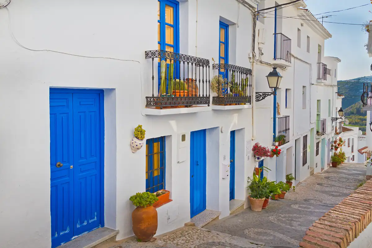 Blue doors on a whitewashed street in the white village of Frigiliana