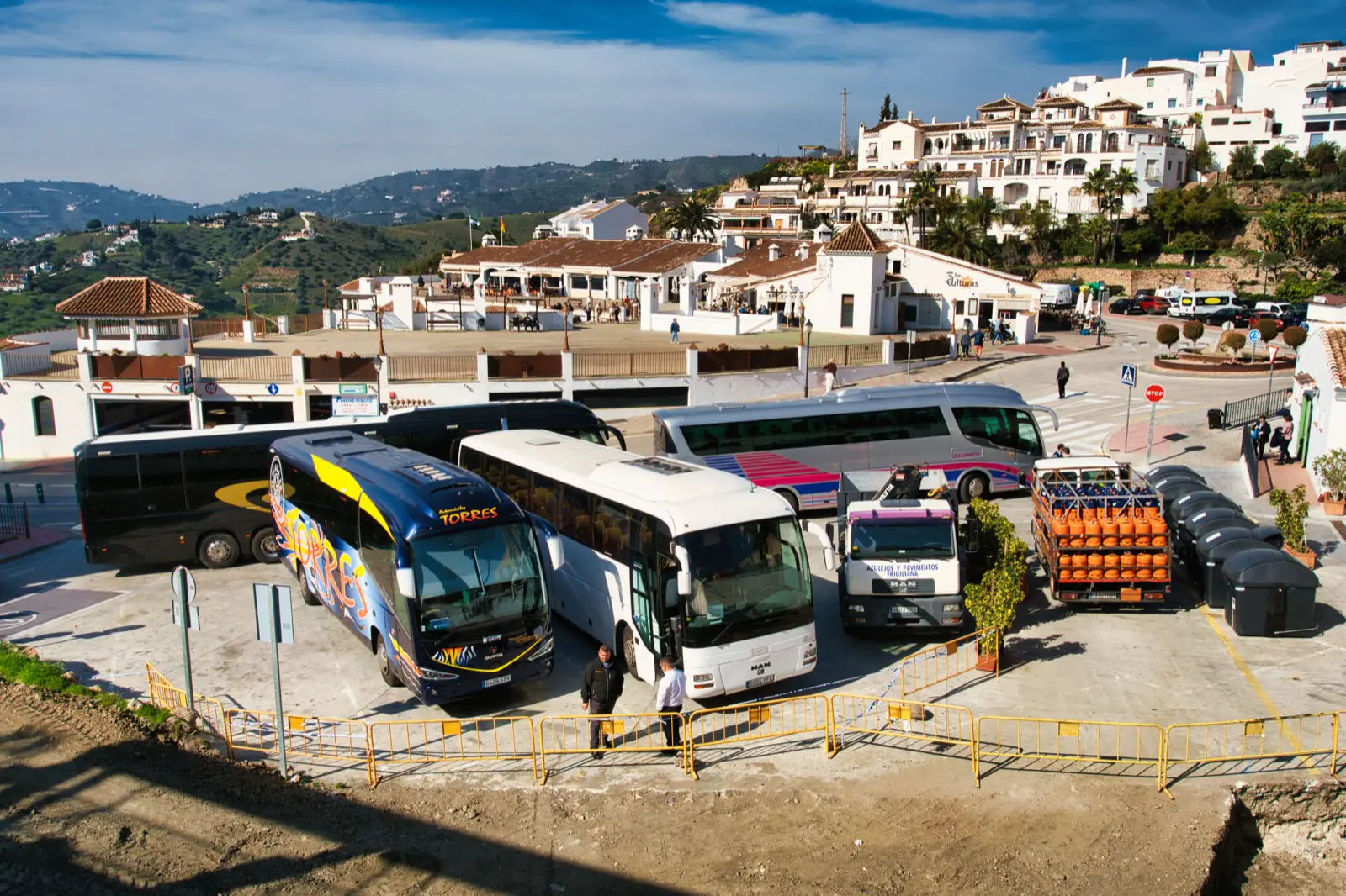 Tour buses parked at Plaza de las Tres Culturas in Frigiliana