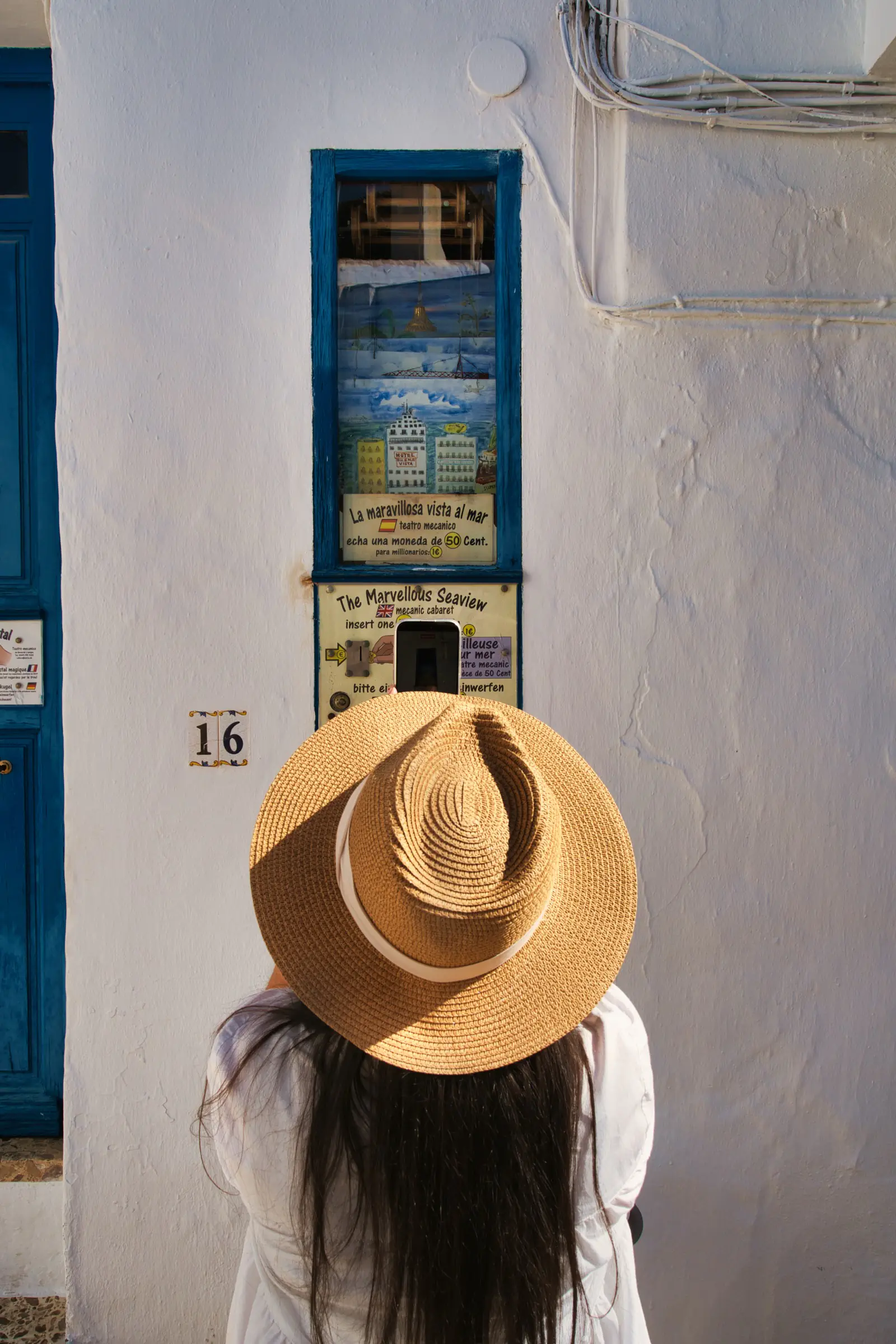 Heidi at an old coin-operated seaview machine in Frigiliana