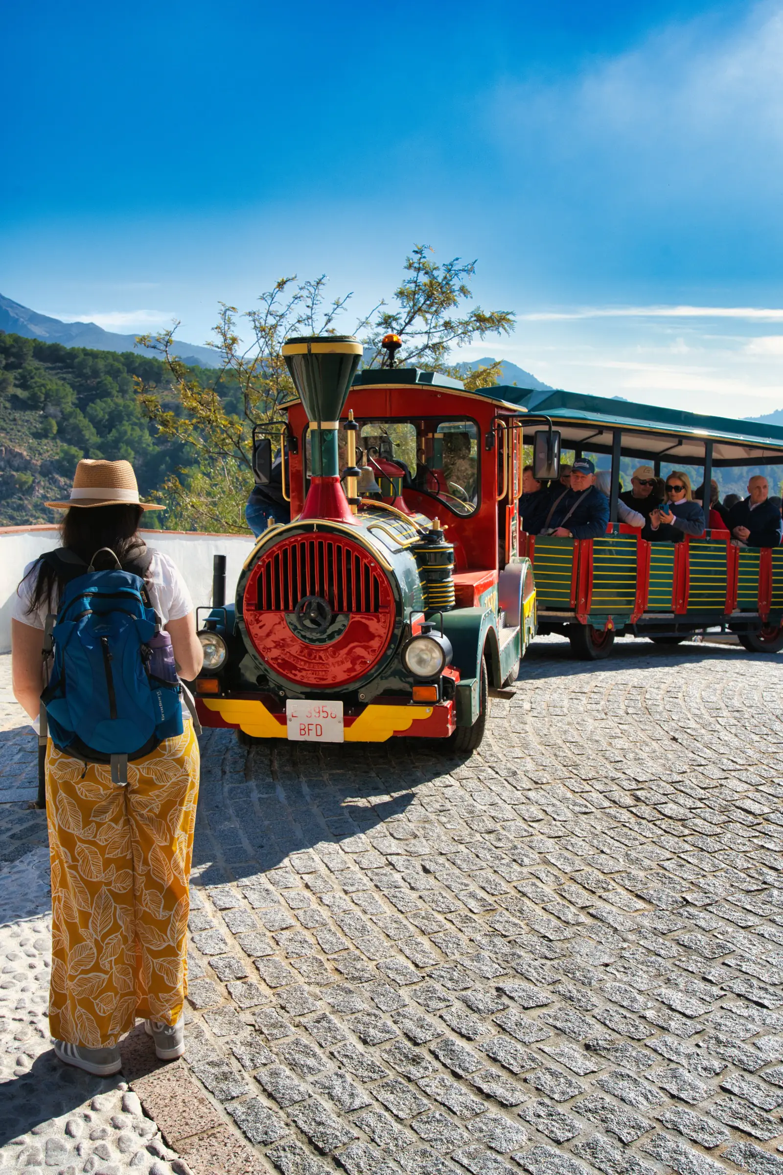 The tourist train passing through a cobbled square in Frigiliana
