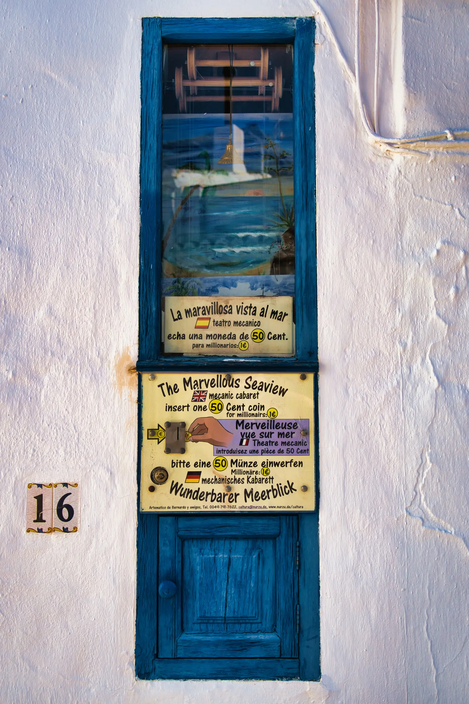 Old-school coin-operated seaview machine on a street in Frigiliana