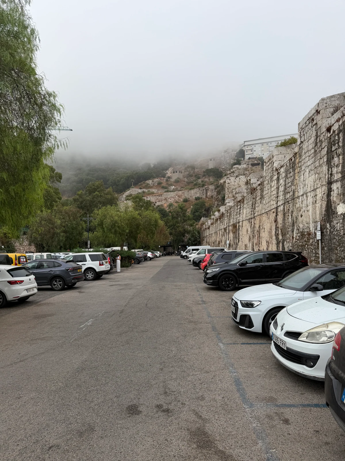 Car park against the old city walls of Gibraltar in morning mist