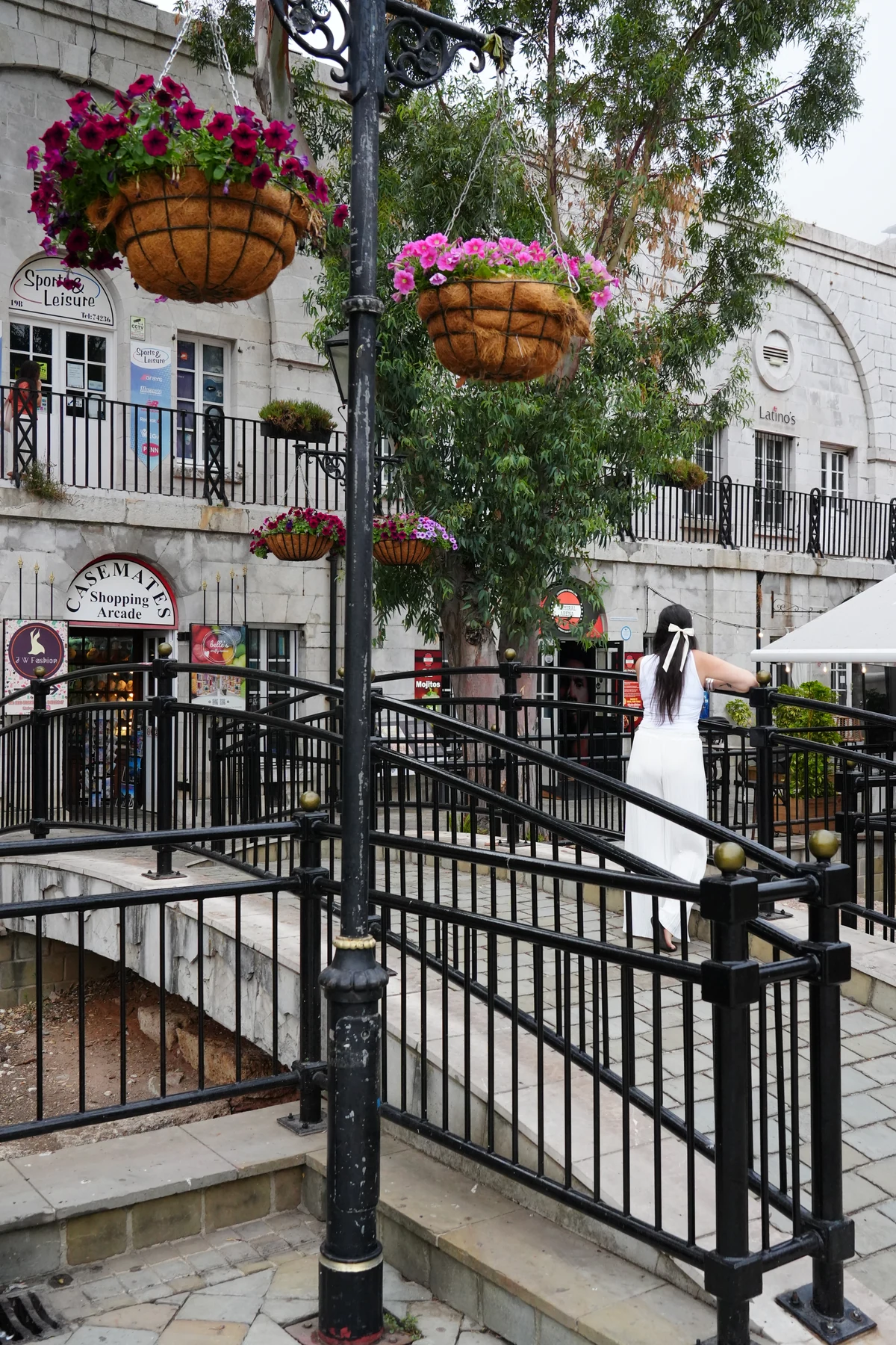 Hanging flower baskets under the arcade at Casemates Square, Gibraltar