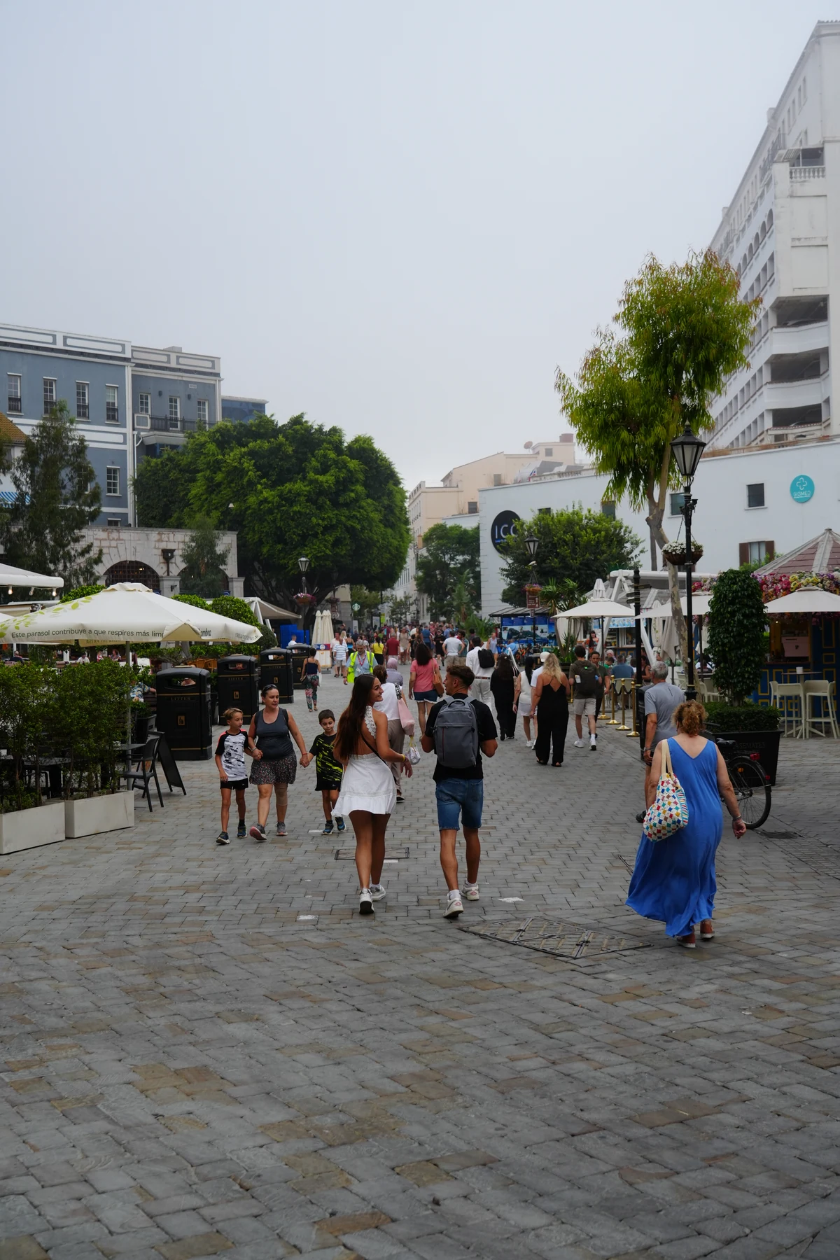 Crowds and restaurant parasols filling Casemates Square in Gibraltar