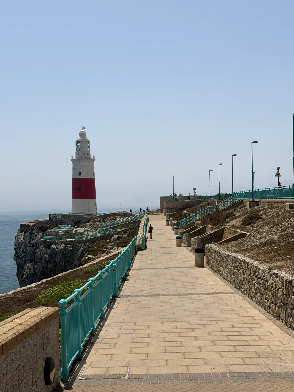Europa Point lighthouse in Gibraltar behind turquoise railings
