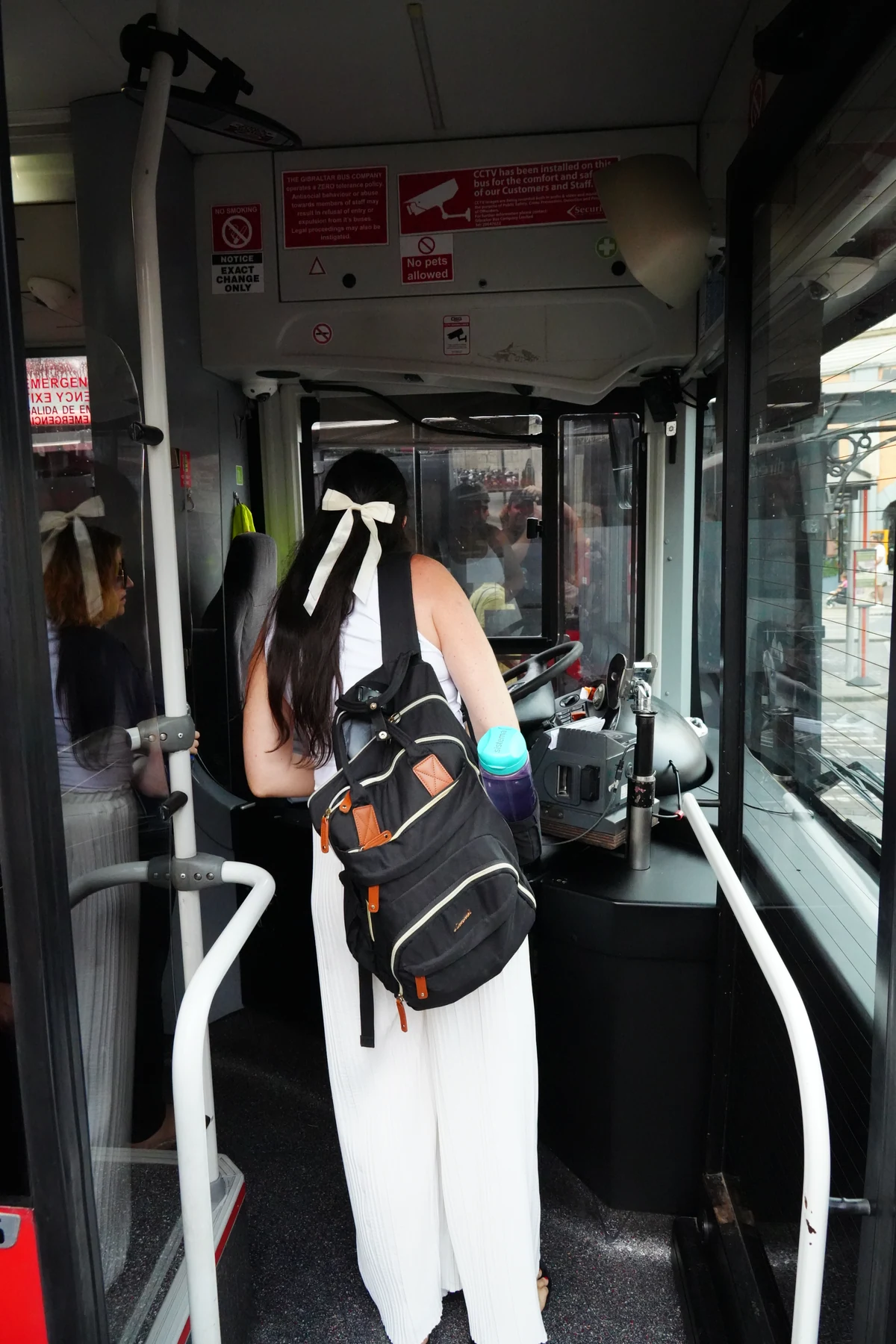 Boarding a public bus and paying the driver in Gibraltar