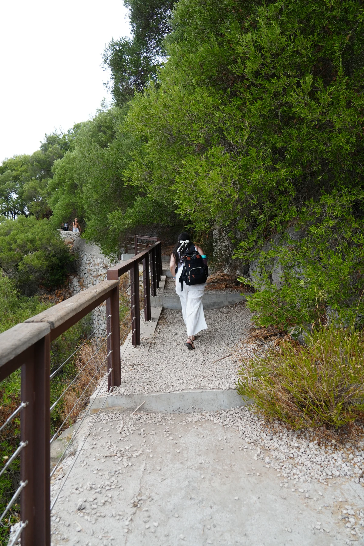 Walking a gravel path beside a wooden railing on the Upper Rock, Gibraltar