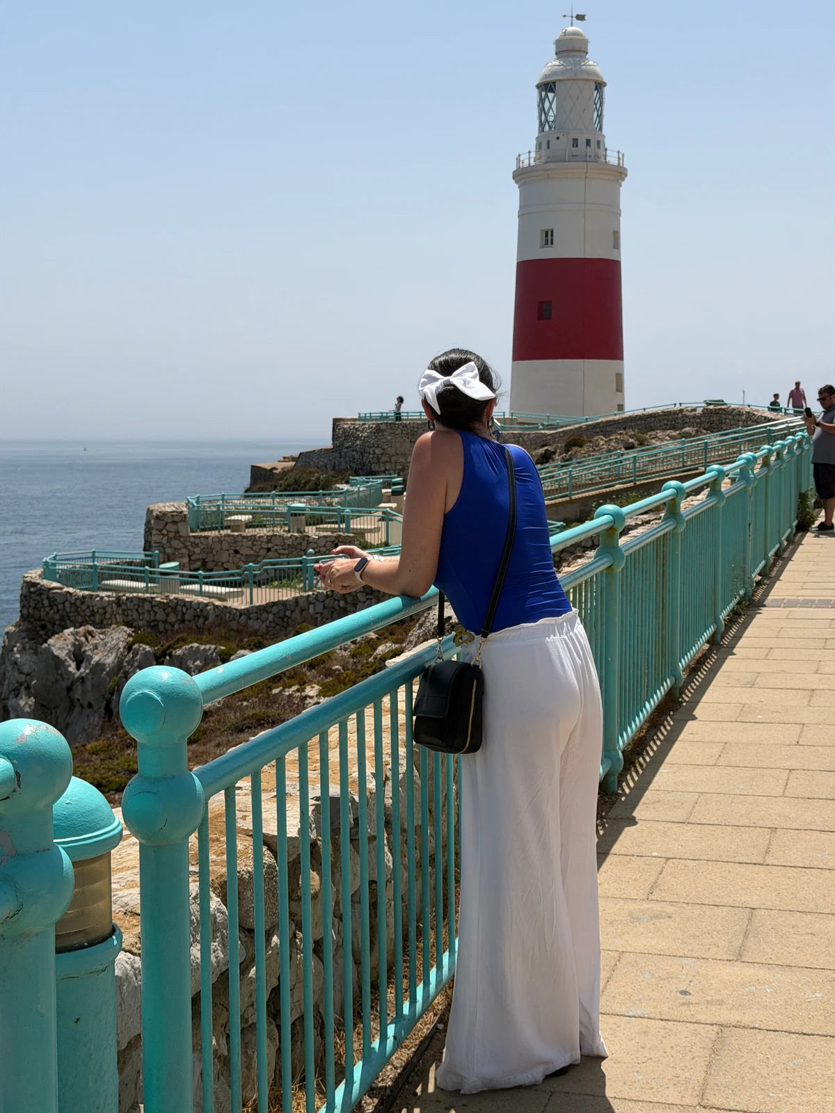 Heidi at the turquoise railings in front of the Europa Point lighthouse, Gibraltar