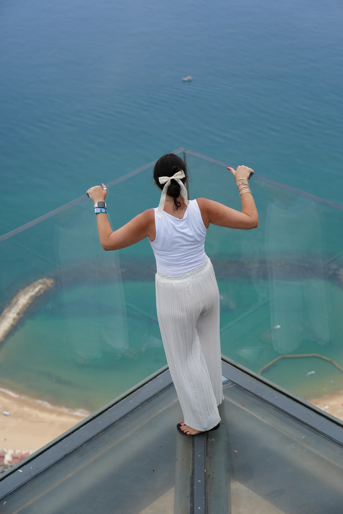 Looking down through the glass floor of the Gibraltar Skywalk to the sea below