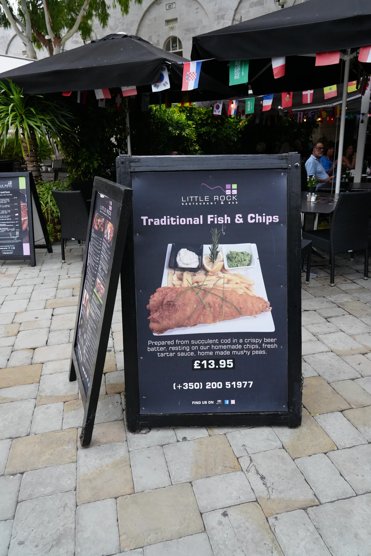 Fish and chips menu board outside a restaurant in Gibraltar