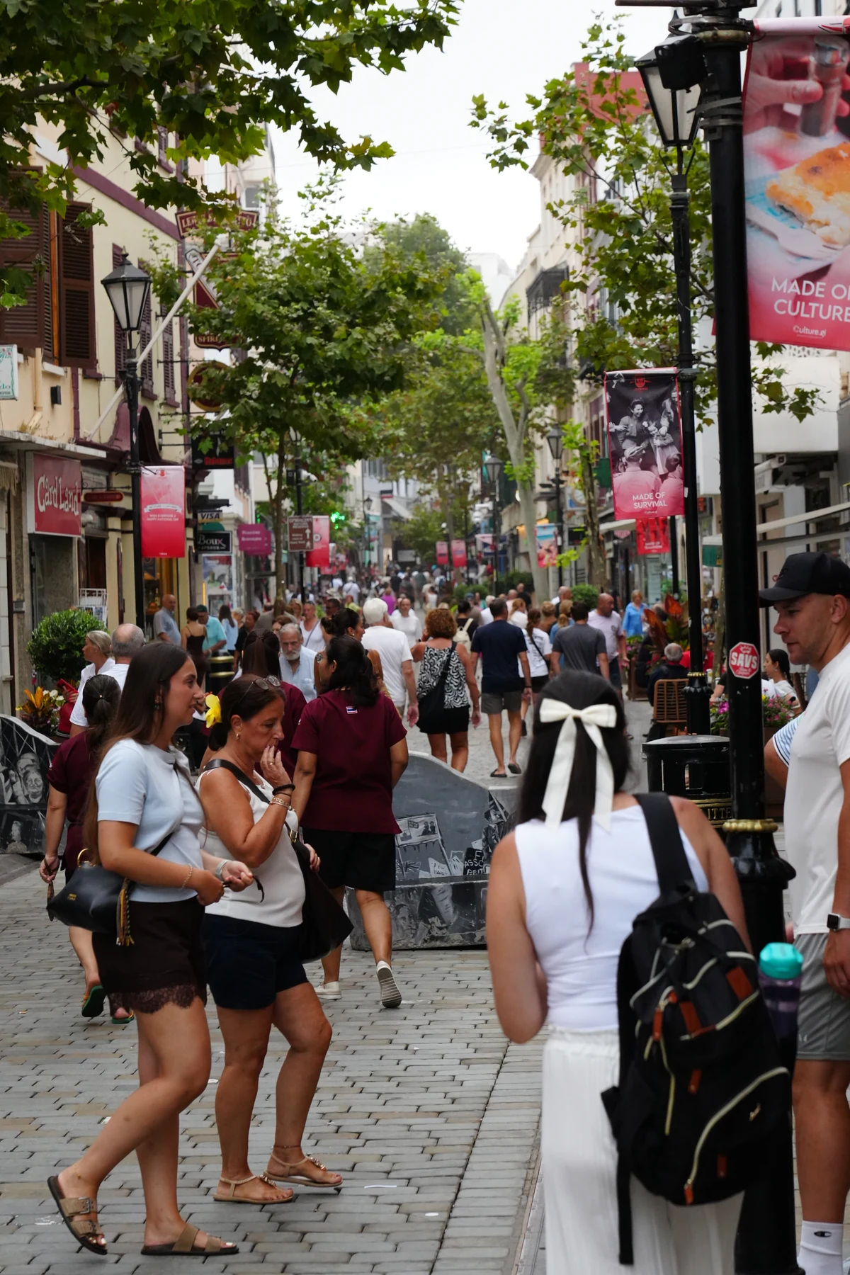 Shoppers and culture banners along Main Street in Gibraltar