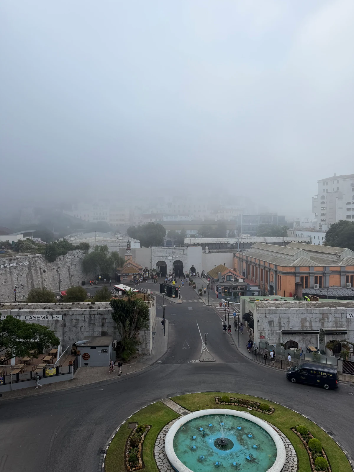 Morning mist over the Casemates gates and fountain roundabout in Gibraltar