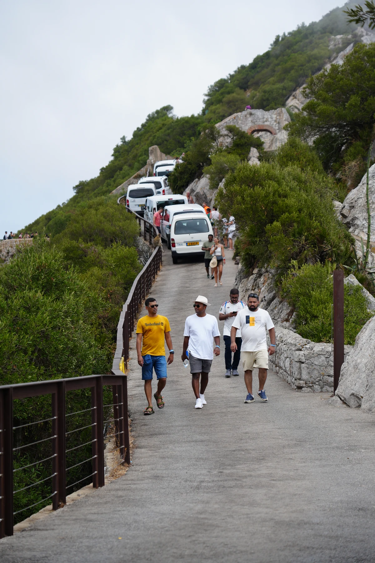 Visitors boarding tour minibuses on the Upper Rock road in Gibraltar