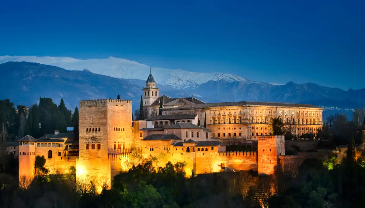 Alhambra palace glowing at sunset viewed from Mirador San Nicolas in Granada
