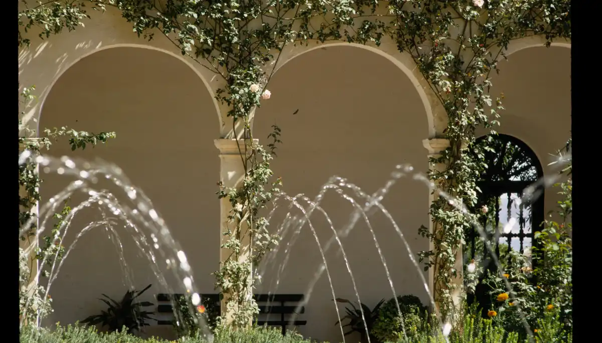 Walled carmen garden glimpsed through an open doorway in the Albaicin