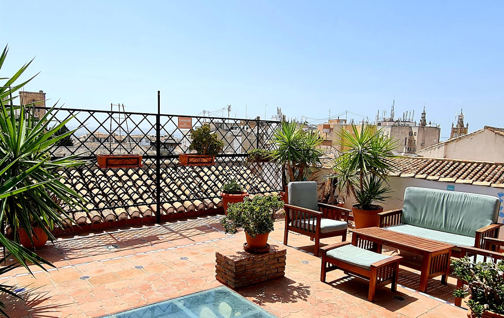 Oasis Backpackers hostel rooftop terrace with views toward the Alhambra