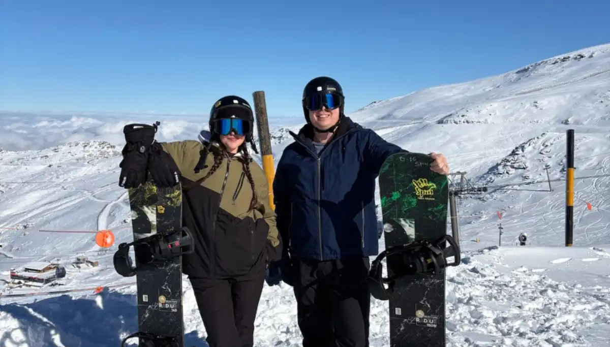 Heidi and Jethro with their snowboards on the Sierra Nevada slopes above Granada