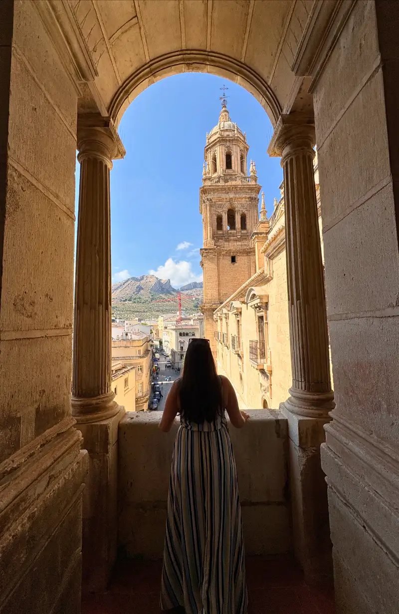 View through a stone archway on Jaén Cathedral roof toward the bell tower