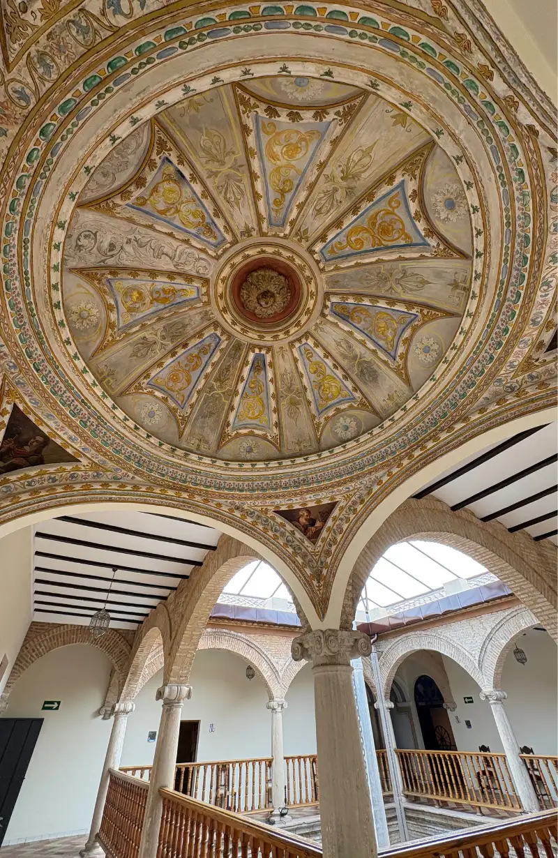 Ornate painted dome ceiling inside a historic building in Jaén