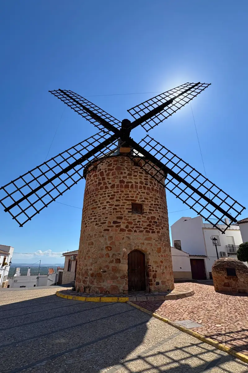 Traditional stone windmill near Burgalimar Castle with views over the Jaen countryside