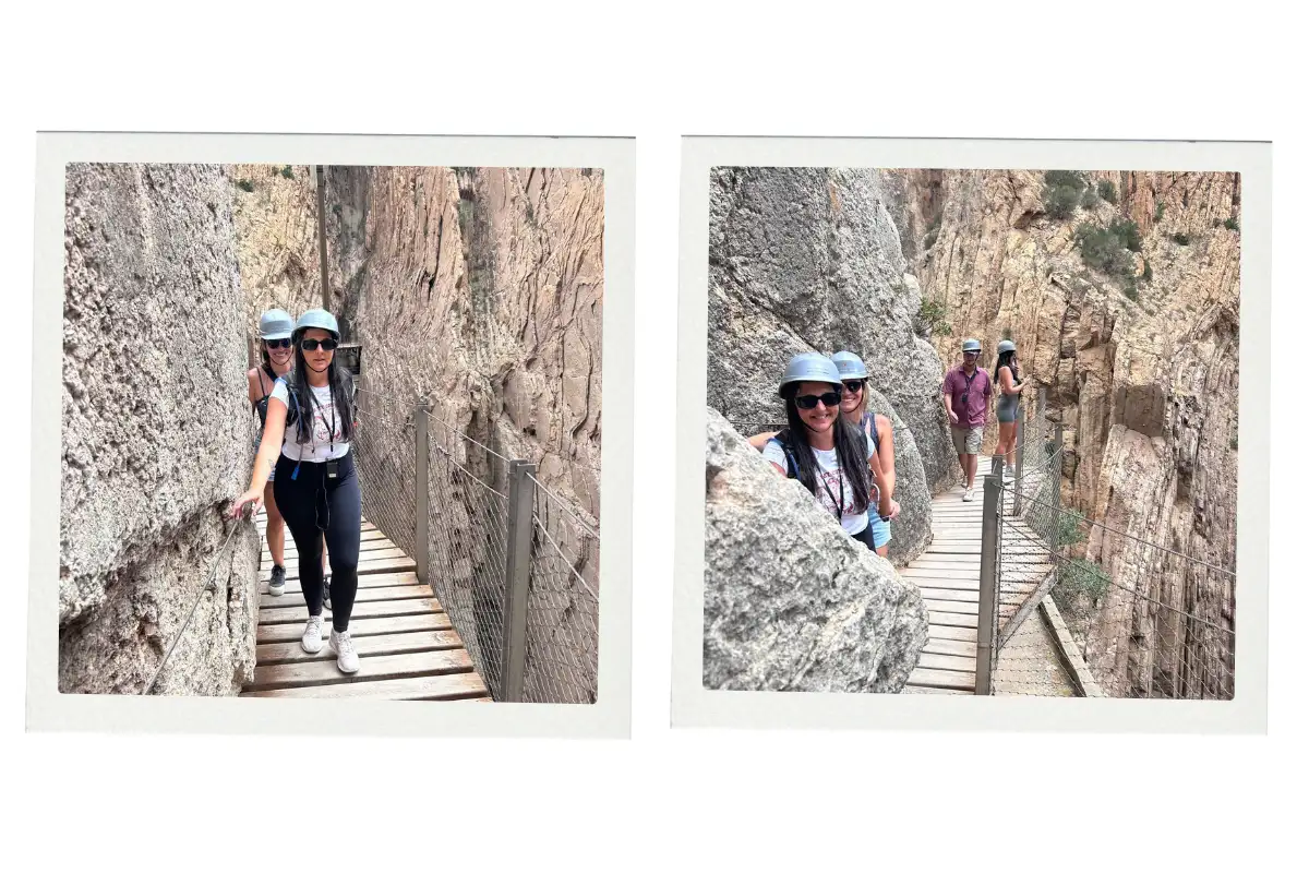 Two women holding hands for safety while walking along the bridge on the Caminito del Rey.