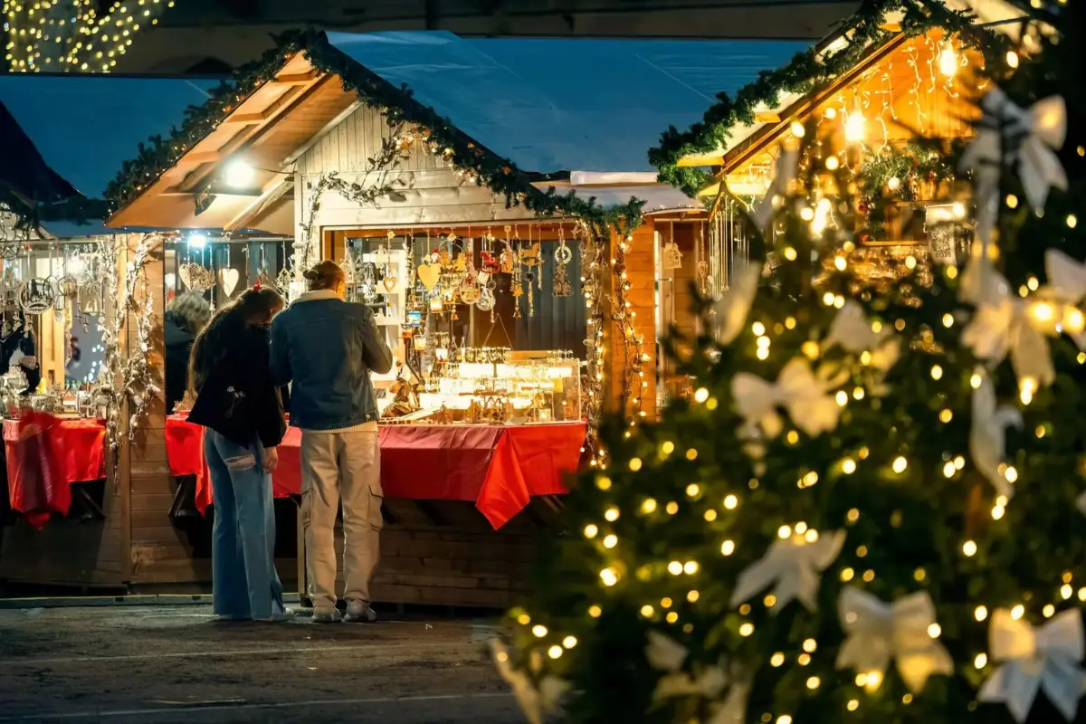 A man and a woman are shopping for jewellery at the Malaga Christmas market.