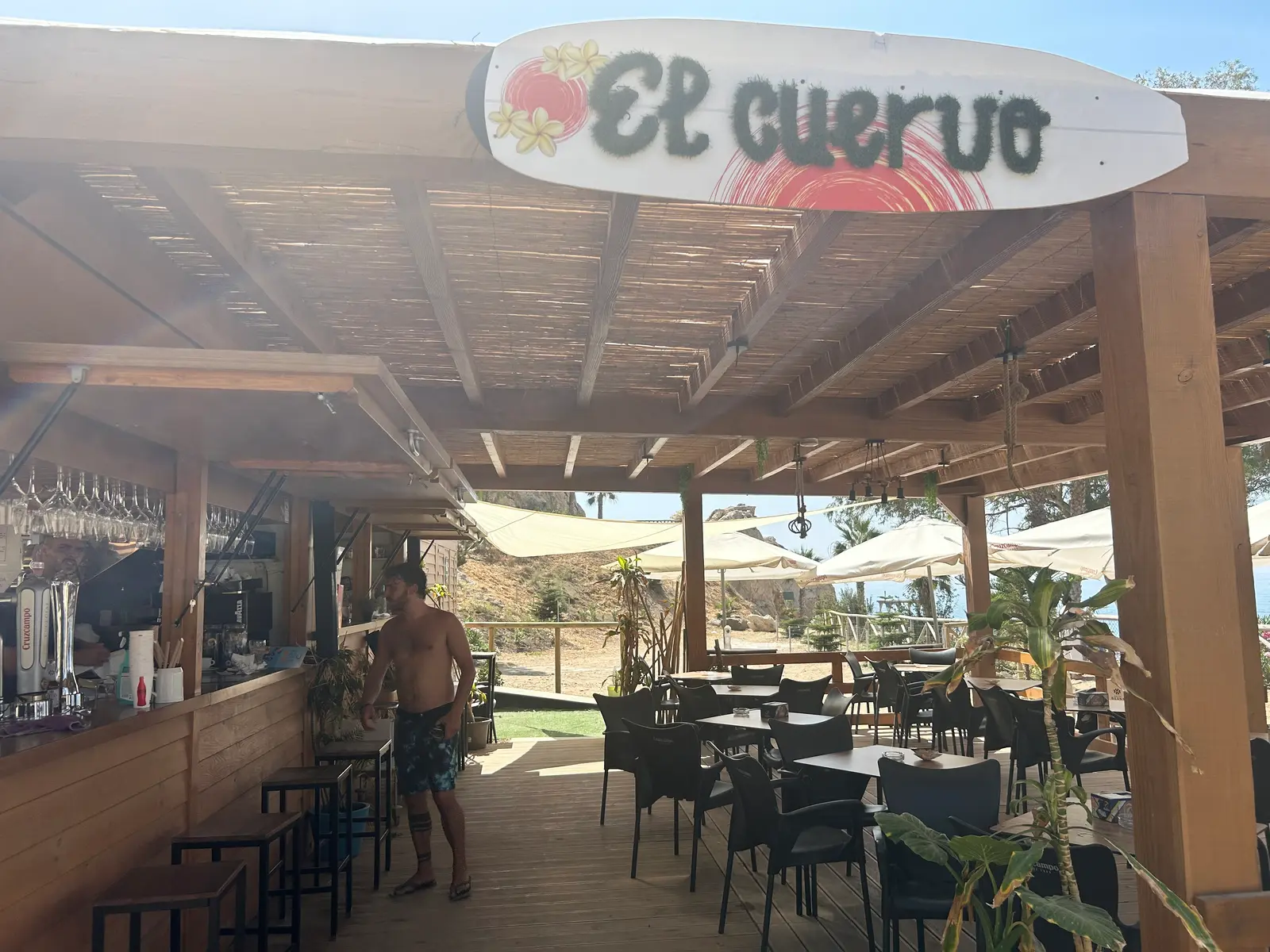 The El Cuervo sign above the bar, with the shaded seating area behind